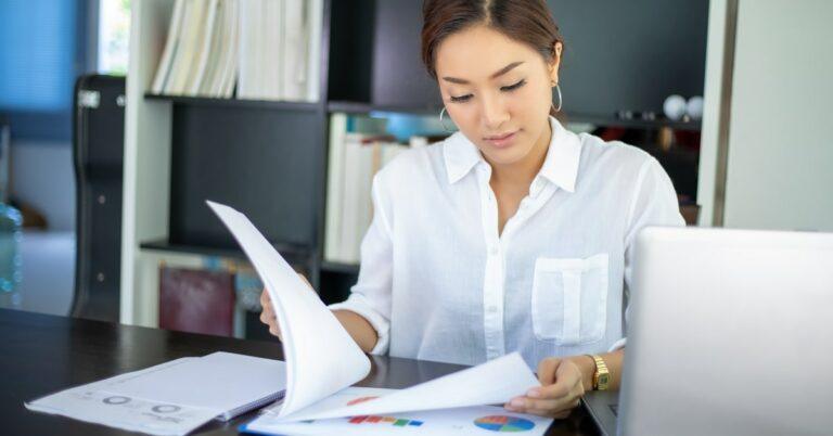 Woman in office checking documents on the desk